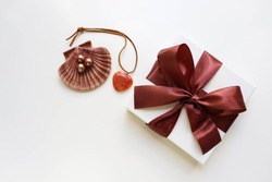 gift concept. gift box with brown bow and jewelry isolated on white background. women's accessories
