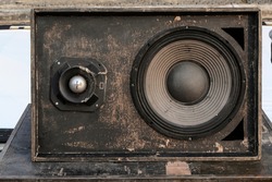 Close-up, speaker cabinet made of wood and placed outdoors on the floor