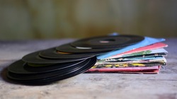 old 45 rpm vinyls dusty and worn by time	
