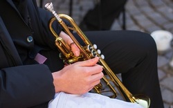 a street trumpeter plays jazz tunes