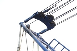 Part of lattice boom crawler crane. Steel cables connected inner bail and boom hoist line for control moving crane up-down. Concept of crawler crane, lattice boom crane, construction equipment.