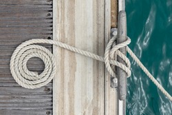 Mooring rope with a knotted end tied around a cleat