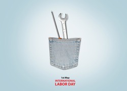 International Labor day concept - Jeans pocket, 2 handy tools with labor day text on gray background.