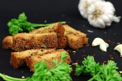Very delicious and crunchy garlic toast with pepper and oregano seasoning garnished with raw garlic and coriander.