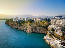 Aerial photograph of Antalya bay in Antalya city from high point of drone fly on sunny day in in Turkey. Amazing aerial cityscape view from birds fly altitude on beautiful town and sea full of yahts
