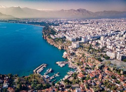 Aerial photograph of Antalya bay in Antalya city from high point of drone fly on sunny day in in Turkey. Wonderful view on the bay full of yachts and boat and with ancient old castle