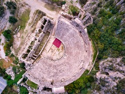 High angle drone aerial view of ancient greek rock cut lykian empire amphitheatre and tombs in Myra (Demre, Turkey)