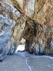 Part of a local beach, with a passage through the rocks as a 