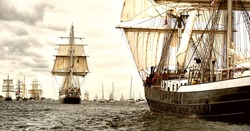 Tall sailing ships race. Travel and tourism at sea. Beautiful sailboats under sail