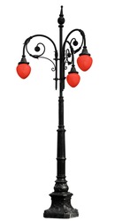 Vintage cast iron lamppost with red light isolated on white background
