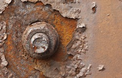 Rusty nut at the surface of steel plate closeup