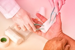 Doctor doing wound dressing care and bandaging patient's hand, Hand surgery treatment, Nurse treat patient's finger injury in hospital.