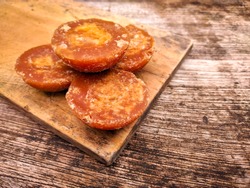 Gula Aren/Merah or Gula Jawa, Indonesian Sugar on wooden trays. Made from nira, which is a liquid extracted from tree flowers from the palma family, such as coconuts, palm, and guide.