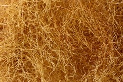 corn silk made from stigmas, stigma maydis, natural yellow thread like strands fiber used as herbal medicine, background texture, macro taken in shallow depth of field