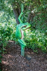 Artificial decoration of a tree frog on a tree in an amusement park