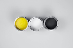 Cans of paint in trendy color combinations. The trendy colors of 2021 are yellow and gray. Trending color combinations of 2021.