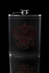 Metal flask in a leather case with a pattern depicting a doubleheaded eagle on a black background