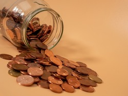 Glass jar with coins. Piggy bank with euro cents. Close-up.
