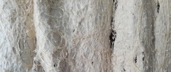 Closeup of worn white cotton rag texture