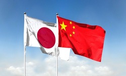 Chinese flag and Japanese flag with blue sky. waving blue sky