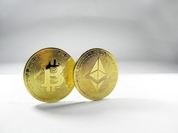 Bitcoin and Ethereum cryptocurrency coins isolated on white background. Cryptocurrency - Image of golden bitcoin physical gold coins and golden ether coins. Symbol of cryptocurrency.        
