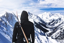 Hooded Person With Skis On Back At Top Of Winter Mountain Extreme Ski Sport Concept