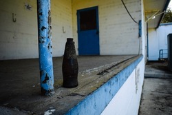 Old bottle outside an abandonded building 