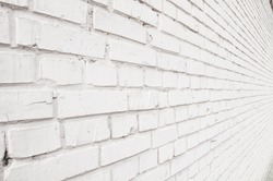 Old white brick wall background in perspective
