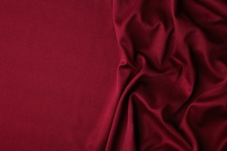 Smooth elegant burgundy silk or satin luxury cloth texture can use as abstract background. Luxurious background design. Top view