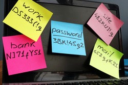 Password management.  Laptop with memo sticks on the screen.