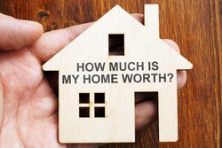 How much is my home worth? Sign on the model of house.