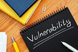 Vulnerability is written in white pencil on a black page.