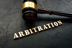 Arbitration word from wooden letters and gavel in court.