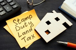 Stamp duty land tax SDLT memo and model of home.