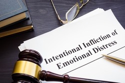 Papers about intentional infliction of emotional distress IIED and a gavel.