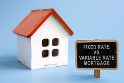 Fixed rate vs variable rate mortgage. Model of the house and a sign next to it.