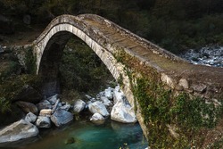 Old Roman bridge in Italian mountains