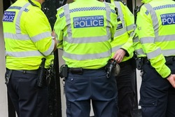 Metropolitan fully equipped Police officer back of the vest in London, UK
