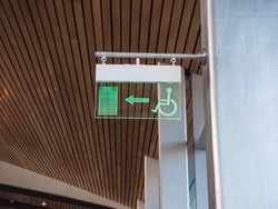 emergency exit sign for disabled people in a business center, airport
