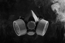 Black gas mask on black background with smoke or toxic gas