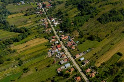 Aerial view of a linear village. Households are bordered by agriculture fields