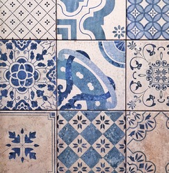 Gray and blue ceramic tiles  with floral and geometric pattern for wall and floor decoration. Old concrete stone surface background. Vintage texture with ornaments for interior design project.