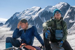 High altitude sickness. Climber holds his head because of headache.