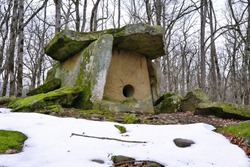 View of ancient dolmen in Pshada river gorge on cloudy winter day. Krasnodar Krai, Caucasus, Russia.