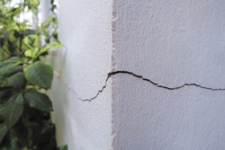Cracked concrete building broken wall at the outside cement corner that effected with earthquake and collapsed ground