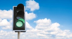 Junction traffic light with green color and blue sky background, that mean you can go