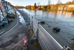 Due to climate change and global warming,emergency flood defenses put in place, to protect homes and businesses near to the river severn,torrents of water pour down from surrounding mountains.