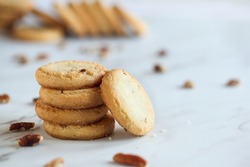 Stack of pecan sandies cookies. Selective focus with blurred foreground and background.