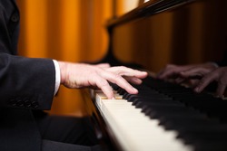 Close up of a musician playing a piano keyboard