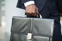 Detail of a businessman holding his briefcase